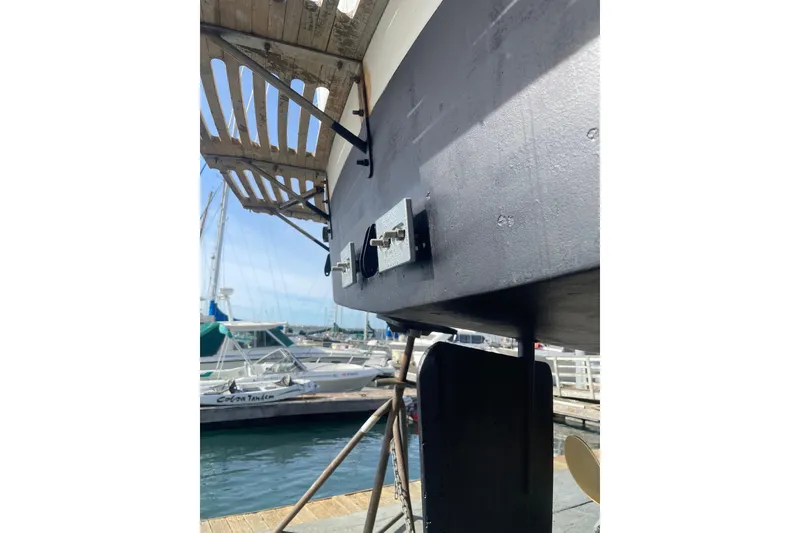 Slide: The Image of 1981 Hershine 40 boat hull and rudder at marina, showcasing nautical craftsmanship. - 33