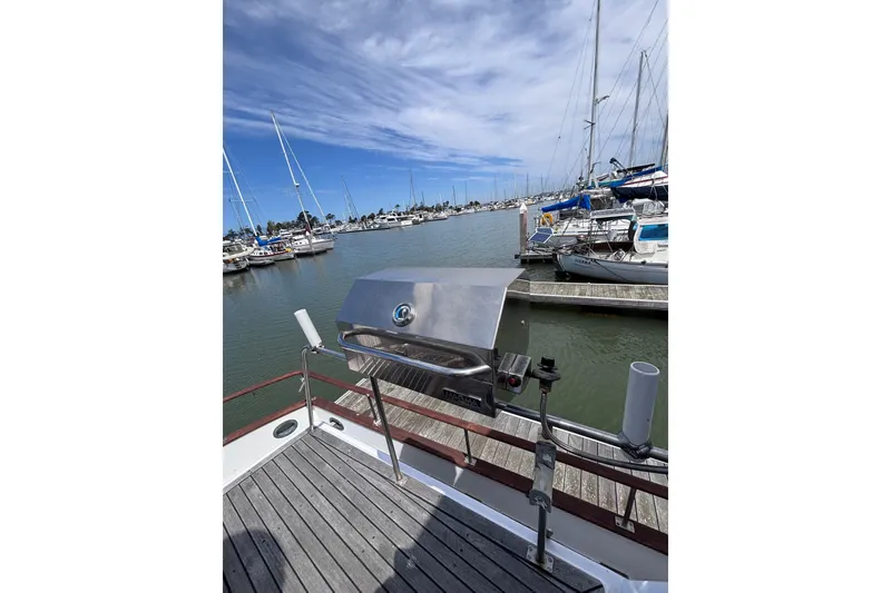 Slide: The Image of 1981 Hershine 40 yacht with grill on deck, docked at marina. - 50