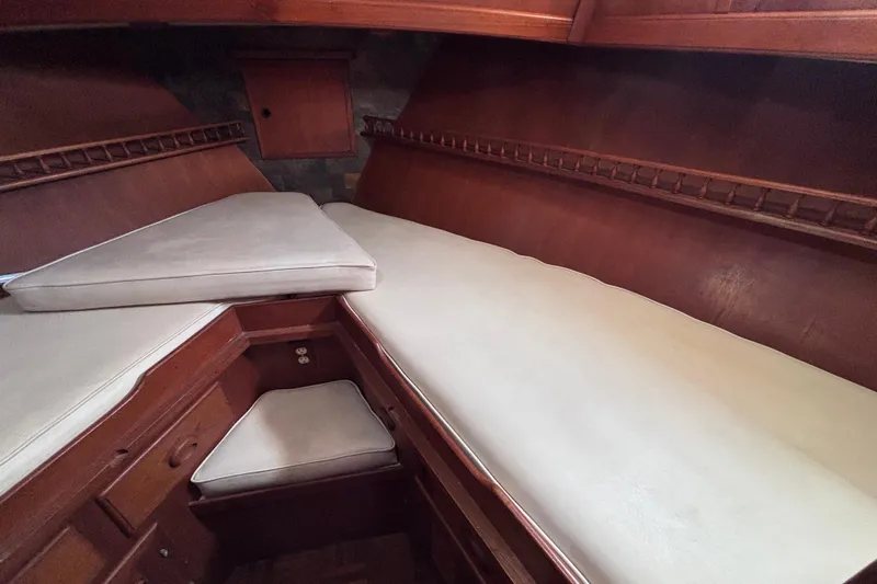 Slide: The Image of Interior cabin of 1981 Hershine 40 yacht with wooden finish and cushioned seating. - 18