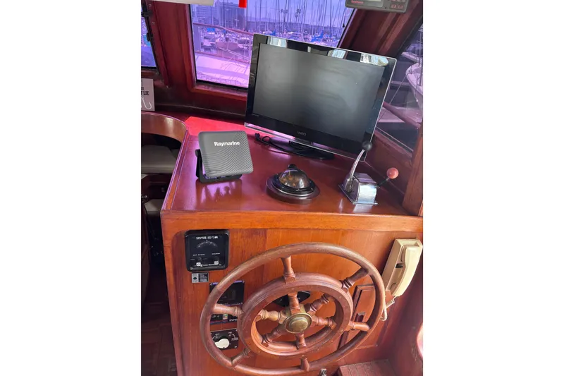 Slide: The Image of Interior helm of 1981 Hershine 40 boat with wooden wheel and navigation equipment. - 32