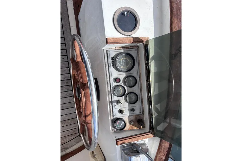 Slide: The Image of 1981 Hershine 40 boat dashboard with wooden steering wheel and instrument panel. - 48