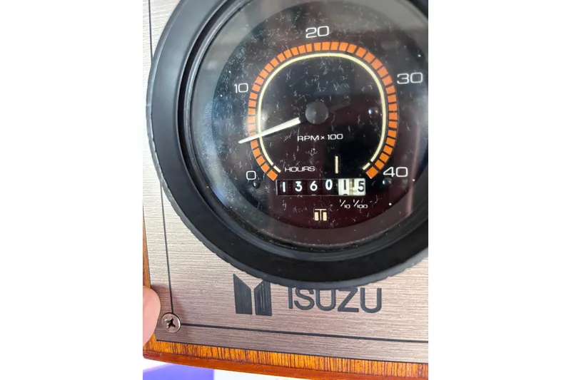 Slide: The Image of Isuzu RPM gauge showing 1360.5 hours on a 1981 Hershine 40 boat. - 21