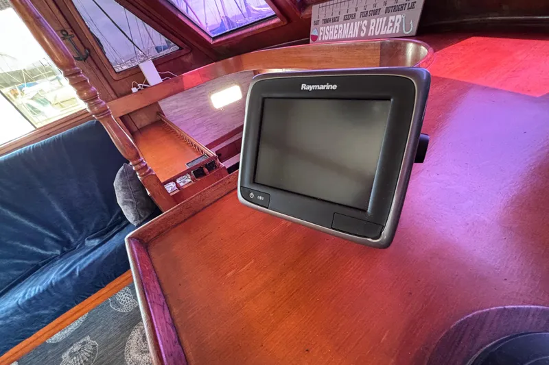 Slide: The Image of Raymarine navigation system on 1981 Hershine 40 yacht's wooden interior helm. - 43