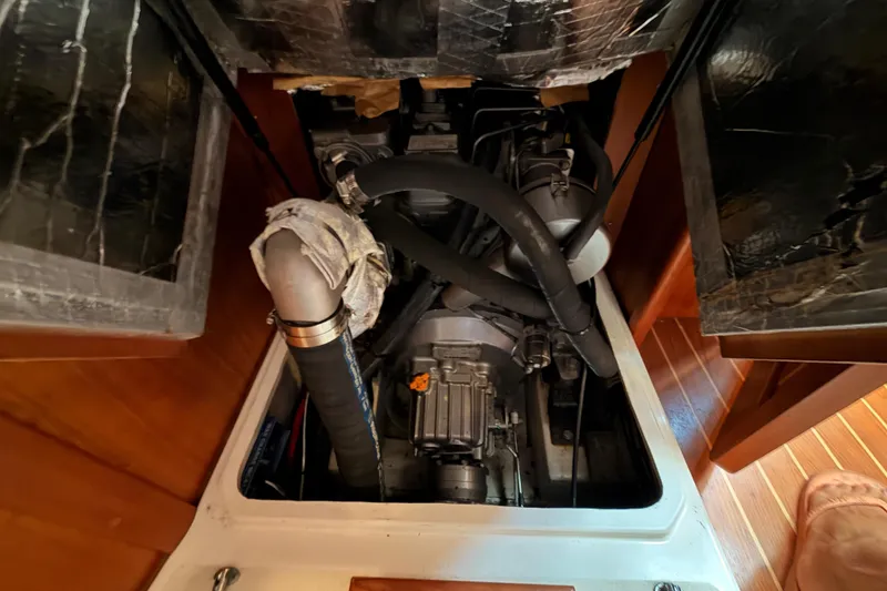 Slide: The Image of Engine compartment of a 2002 Tartan 3700 sailboat, showcasing mechanical components. - 76