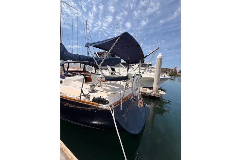 Slide: The Image of Sailboat Tartan 3700, 2002 model, docked at marina under clear sky. - 14