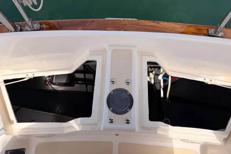 Slide: The Image of Open compartments on a 2002 Tartan 3700 sailboat deck, showing interior wiring and fittings. - 104