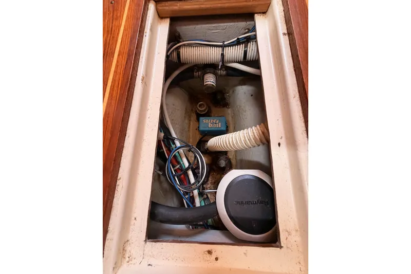 Slide: The Image of Bilge compartment of 2002 Tartan 3700 sailboat with wiring and hoses. - 99