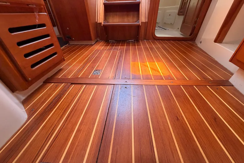 Slide: The Image of Wooden interior flooring of a 2002 Tartan 3700 sailboat cabin. - 98
