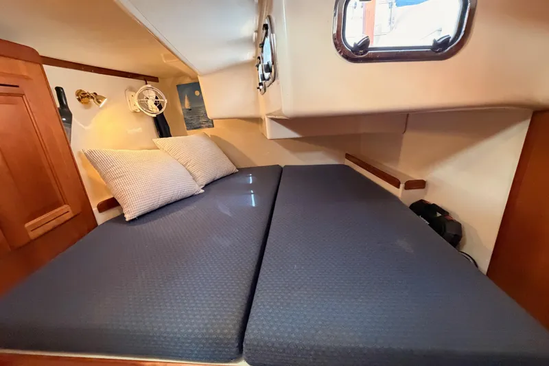 Slide: The Image of Cozy cabin interior of 2002 Tartan 3700 yacht with blue bedding and wooden accents. - 75