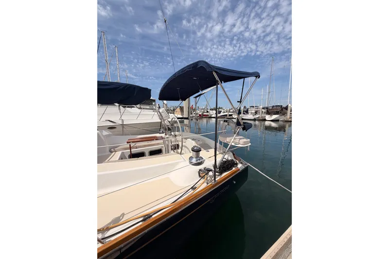 Slide: The Image of Tartan 3700 sailboat from 2002 docked in a marina under a clear sky. - 13
