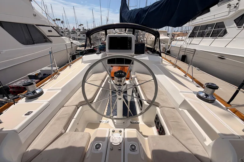 Slide: The Image of Cockpit of 2002 Tartan 3700 sailboat with steering wheel and navigation equipment. - 37