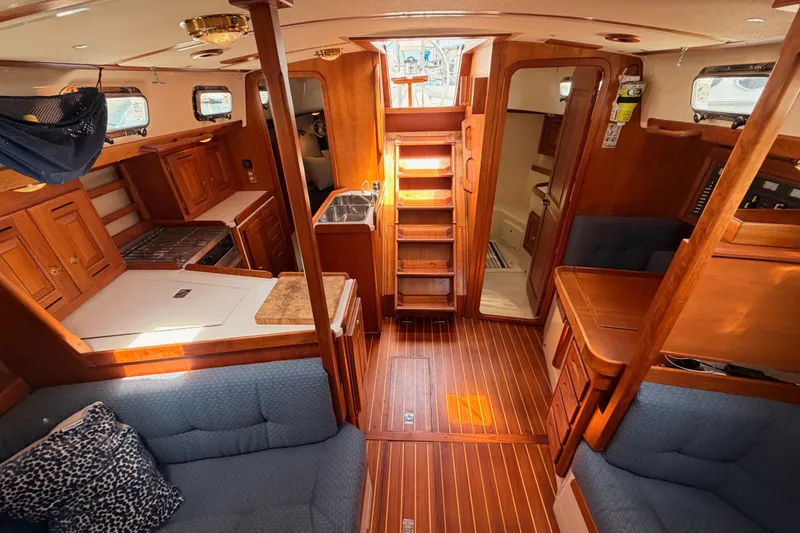 Slide: The Image of Interior of 2002 Tartan 3700 sailboat with wooden cabinetry and seating. - 97