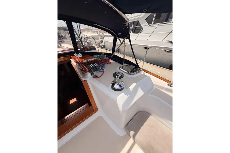Slide: The Image of 2002 Tartan 3700 sailboat cockpit with winch and ropes, docked at marina. - 45