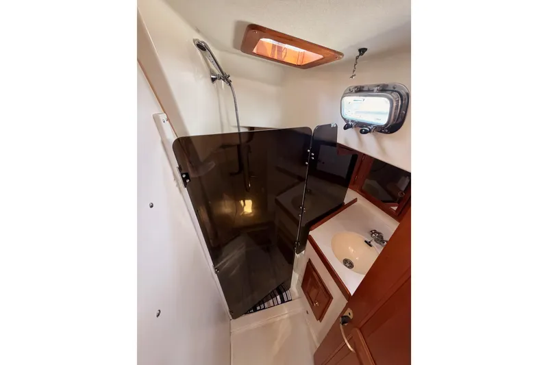 Slide: The Image of Interior of 2002 Tartan 3700 yacht bathroom with shower and sink. - 59