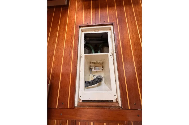 Slide: The Image of Wood-paneled interior of 2002 Tartan 3700 sailboat with open electrical panel. - 100
