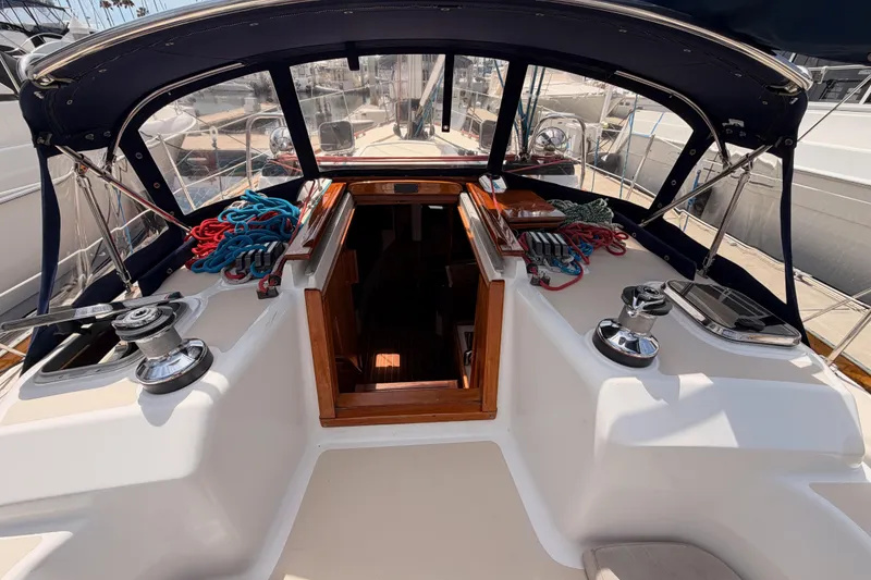 Slide: The Image of Cockpit of 2002 Tartan 3700 sailboat with ropes and winches, docked at marina. - 43