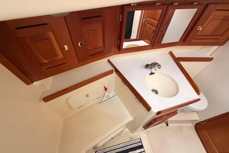 Slide: The Image of Wooden cabinetry and sink in 2002 Tartan 3700 yacht bathroom. - 56