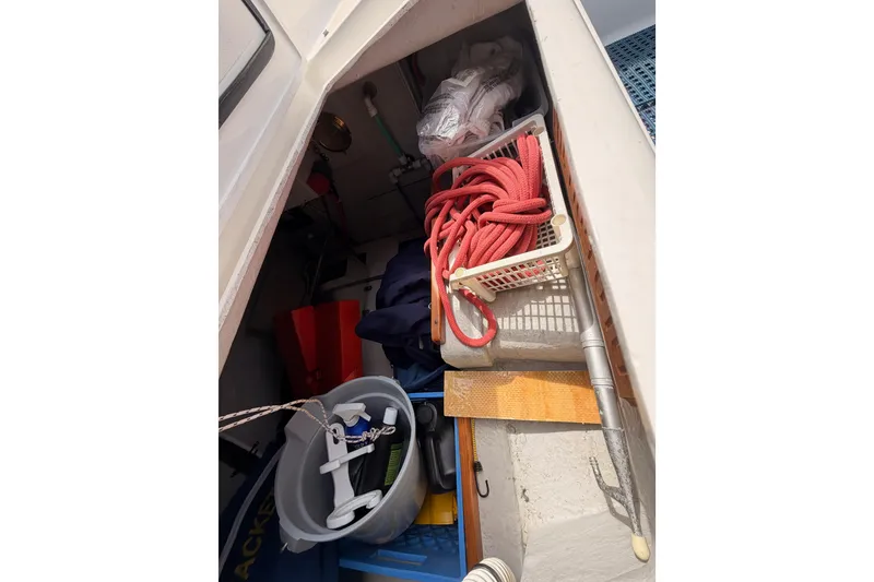 Slide: The Image of Storage compartment of a 2002 Tartan 3700 sailboat with ropes and equipment. - 102