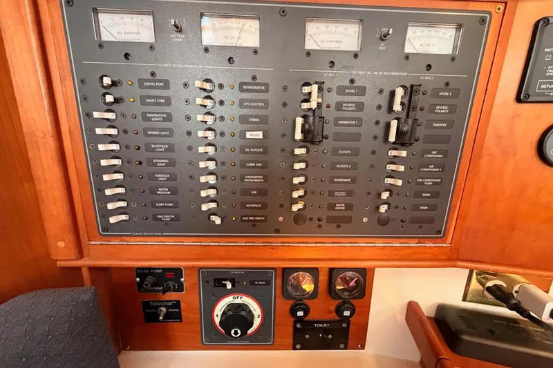 Slide: The Image of Electrical control panel on a 2002 Tartan 3700 yacht, featuring switches and gauges. - 50