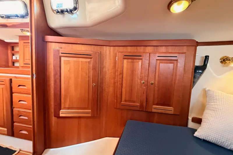 Slide: The Image of Interior of a 2002 Tartan 3700 sailboat featuring wooden cabinetry and cozy seating. - 78