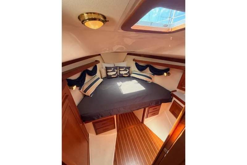 Slide: The Image of Cozy cabin interior of 2002 Tartan 3700 yacht with elegant bedding and wooden accents. - 89