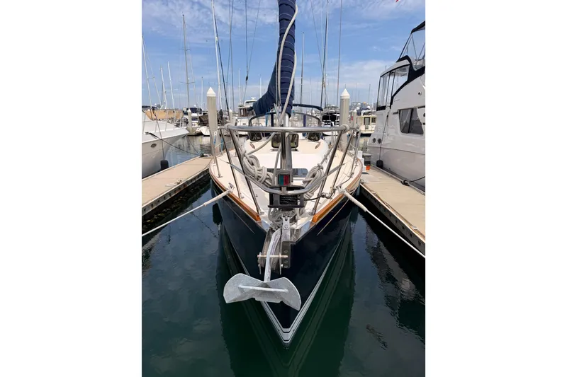 Slide: The Image of Front view of a 2002 Tartan 3700 sailboat docked at a marina. - 7