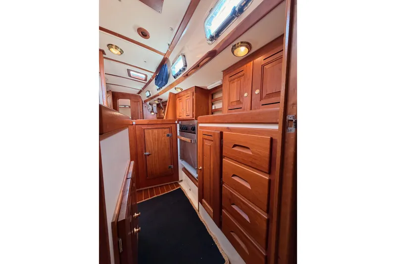 Slide: The Image of Interior of 2002 Tartan 3700 sailboat with wooden cabinetry and modern fixtures. - 79