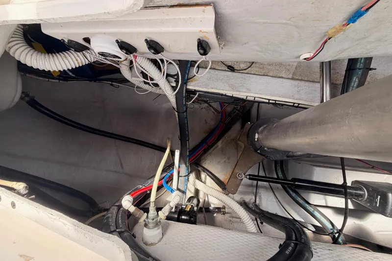Slide: The Image of Interior view of a 2002 Tartan 3700 sailboat, showcasing wiring and mechanical components. - 106