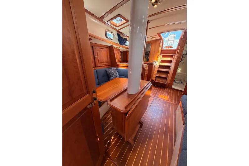 Slide: The Image of Interior of 2002 Tartan 3700 sailboat with wooden furnishings and seating area. - 95
