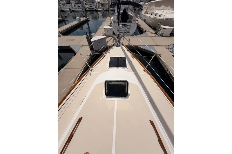 Slide: The Image of Deck view of a 2002 Tartan 3700 sailboat docked at a marina. - 20