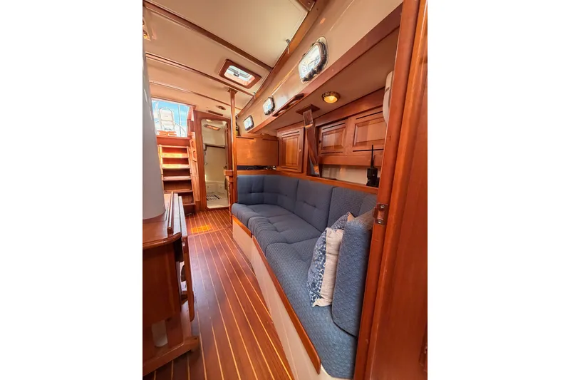 Slide: The Image of Interior of 2002 Tartan 3700 yacht with blue seating and wooden finishes. - 94