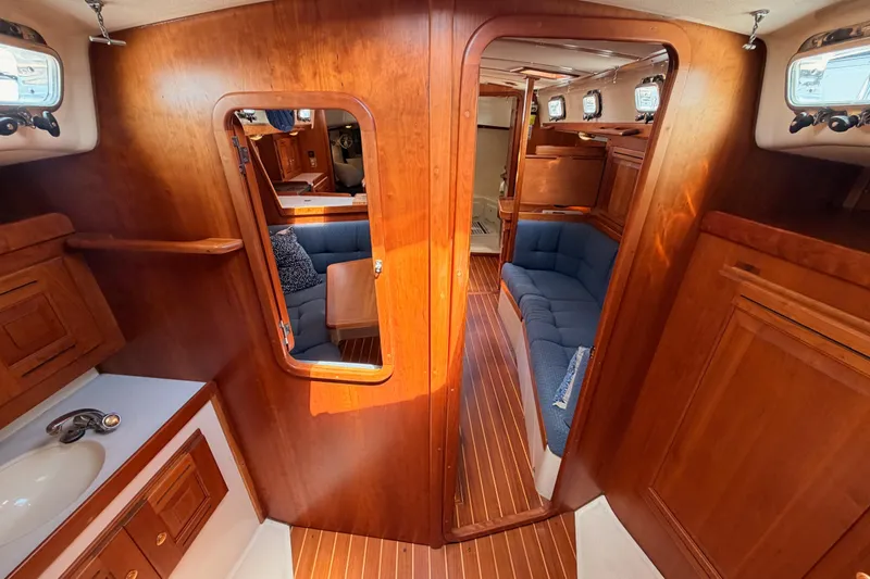Slide: The Image of Luxurious 2002 Tartan 3700 yacht interior with wooden finish and cozy seating area. - 93