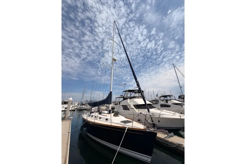 Slide: The Image of Sailboat Tartan 3700, 2002 model, docked at marina under cloudy sky. - 1