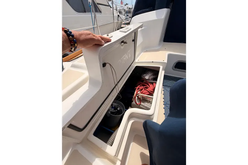 Slide: The Image of Open storage compartment on a 2002 Tartan 3700 sailboat, revealing ropes and equipment. - 101