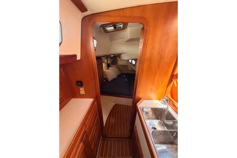 Slide: The Image of Interior of 2002 Tartan 3700 sailboat with wood finish and compact cabin space. - 71