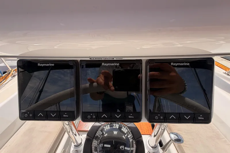 Slide: The Image of Raymarine navigation displays on a 2002 Tartan 3700 yacht dashboard. - 39