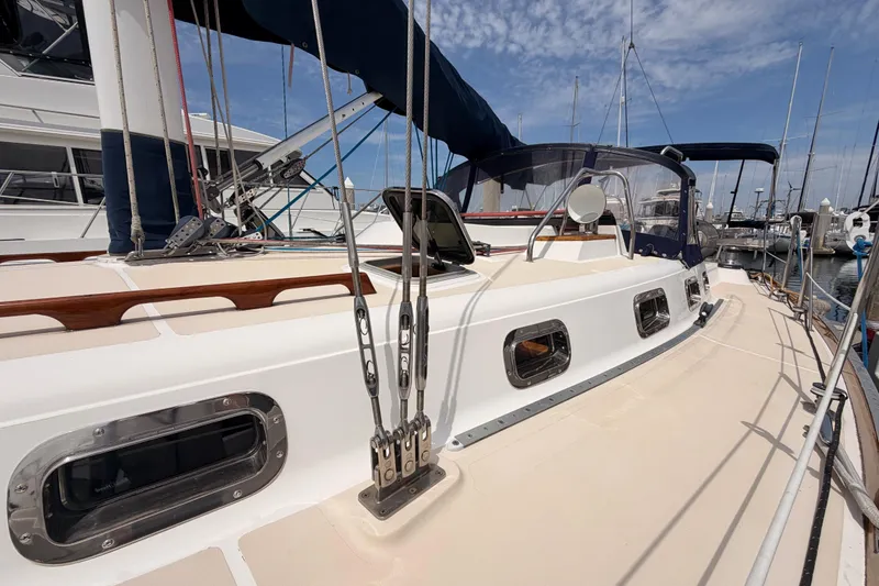Slide: The Image of 2002 Tartan 3700 sailboat deck with rigging and marina background. - 11