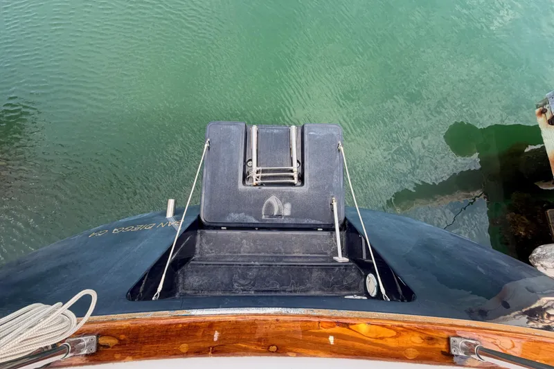 Slide: The Image of Top view of a 2002 Tartan 3700 sailboat stern, docked in clear green water. - 34