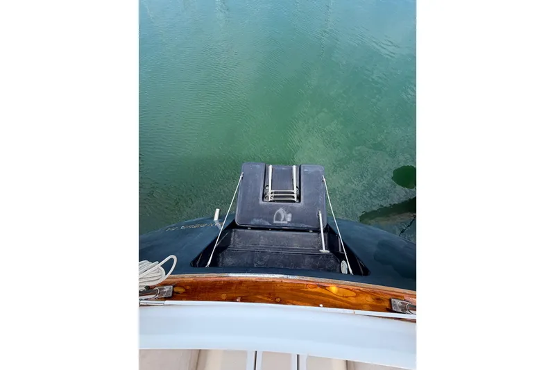 Slide: The Image of Tartan 3700 sailboat stern view, 2002 model, on calm green water. - 33