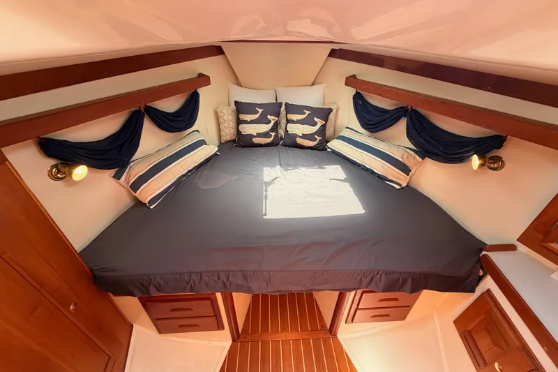 Slide: The Image of Cozy cabin interior of 2002 Tartan 3700 yacht with nautical-themed bedding. - 90