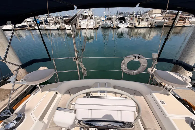 Slide: The Image of Cockpit view of a 2002 Tartan 3700 sailboat docked at a marina. - 28