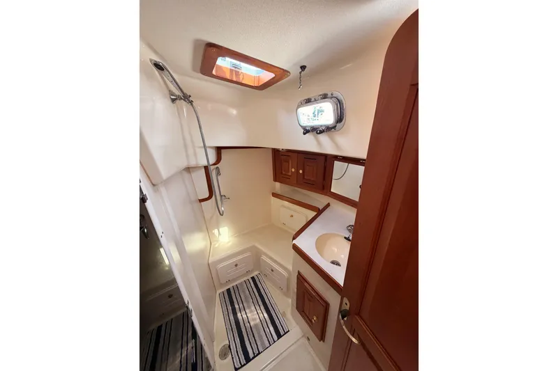 Slide: The Image of Luxurious bathroom interior of 2002 Tartan 3700 yacht with shower and wooden cabinetry. - 55