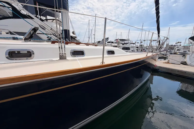 Slide: The Image of Sleek 2002 Tartan 3700 sailboat docked in marina, showcasing elegant design and craftsmanship. - 6