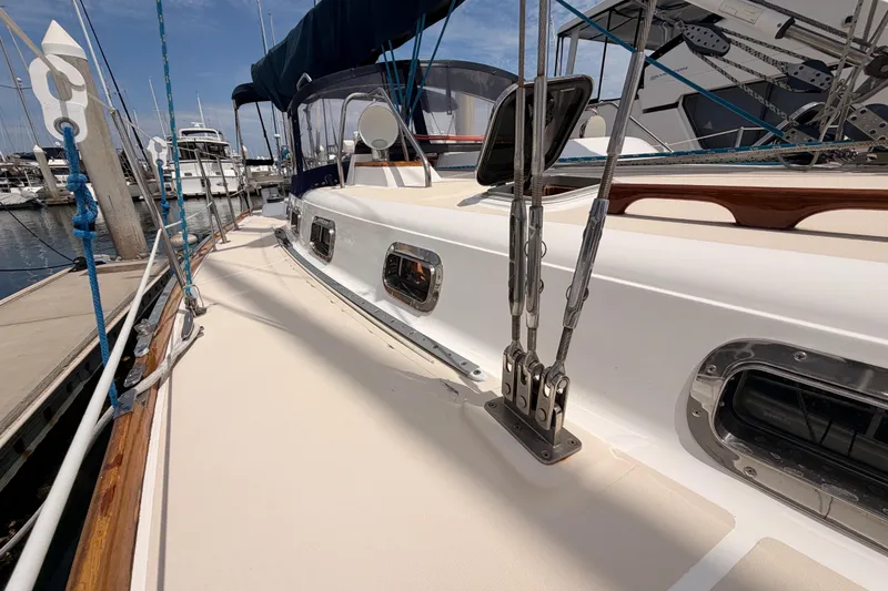 Slide: The Image of Sailboat deck view of 2002 Tartan 3700 at marina, showcasing rigging and sleek design. - 24