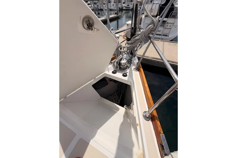 Slide: The Image of Tartan 3700 sailboat deck, 2002 model, featuring open storage compartment and dock view. - 21