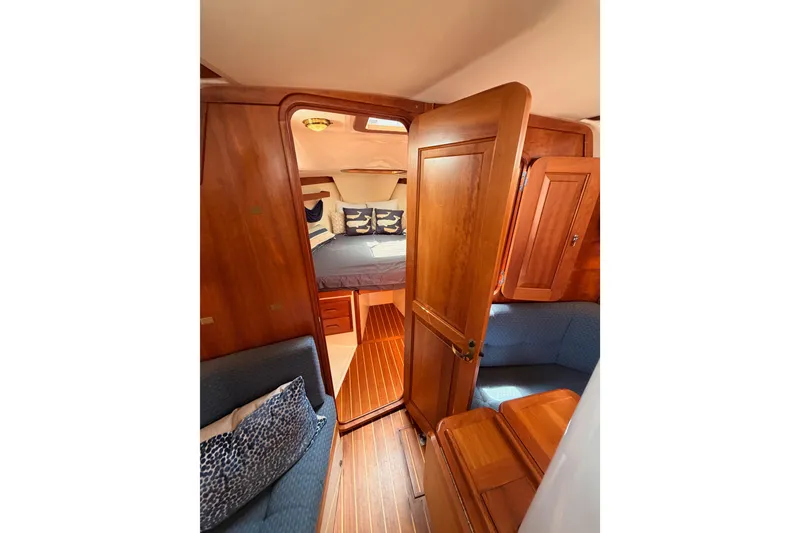 Slide: The Image of Interior of 2002 Tartan 3700 sailboat with wooden finishes and cozy cabin space. - 88