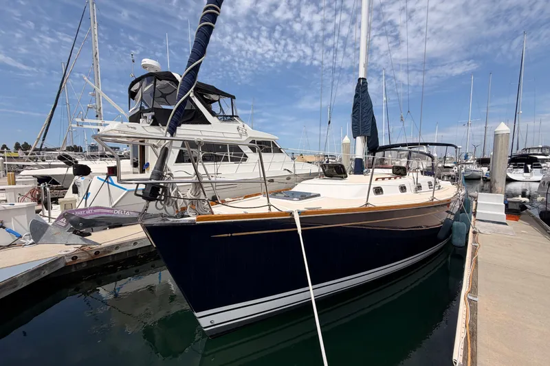 Slide: The Image of Sailboat Tartan 3700, 2002 model, docked at marina under blue sky. - 8
