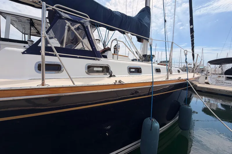 Slide: The Image of Sailboat Tartan 3700, 2002 model, docked in marina with blue fenders. - 5