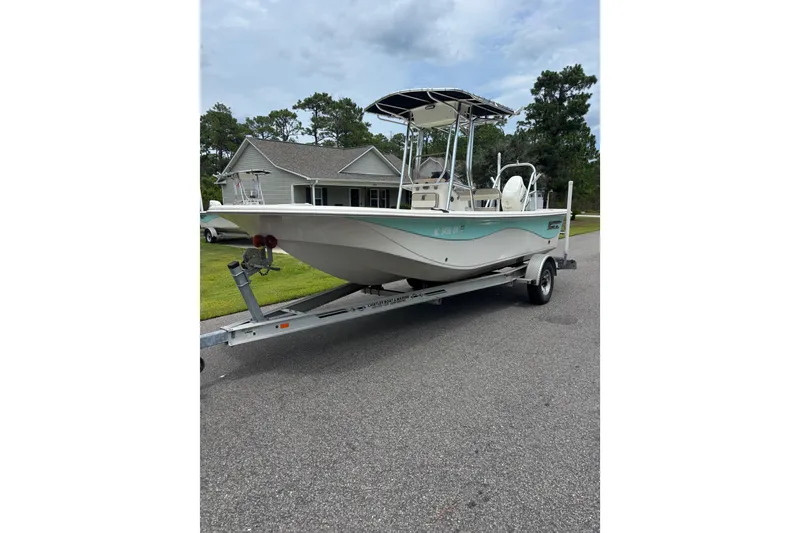 Slide: The Image of 2020 Carolina Skiff 21 LS boat on trailer, parked in residential area. - 2