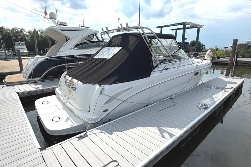 The Image of 2006 Searay 290 AMBERJACK docked at marina, covered with black canopy. - 1